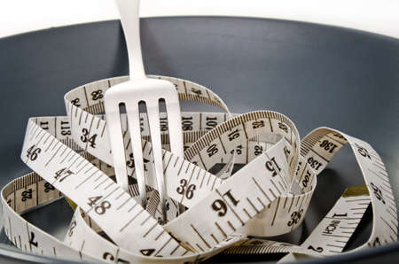 Diet concept  Plate fork and measure tape の写真素材