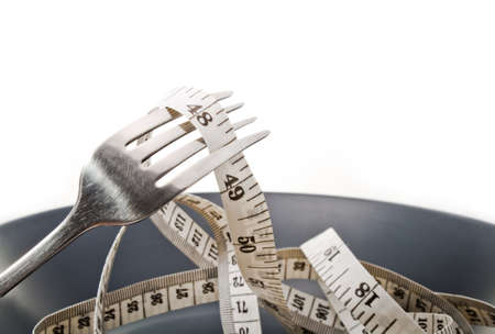 Diet concept  Plate fork and measure tape の写真素材