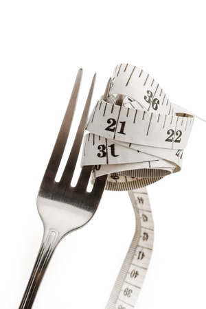Diet concept  fork and measuring tape for healthy lifestyle の写真素材