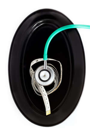 Health and diet concept  Plates and measure tape with stethoscope の写真素材