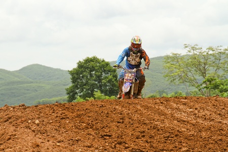 Motocross bike in a race. 
FMSCT Thailand Supercross 2013, Round 7 - Saraburi Race 
Nawaphop MX Muaklek Saraburi Thailand on August 4, 2013.のeditorial素材