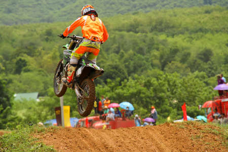 Motocross bike in a race. 
FMSCT Thailand Supercross 2013, Round 7 - Saraburi Race 
Nawaphop MX Muaklek Saraburi Thailand on August 4, 2013.のeditorial素材