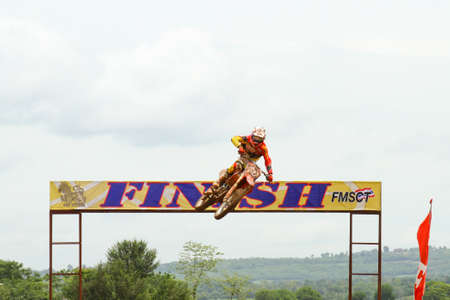 Motocross bike in a race. 
FMSCT Thailand Supercross 2013, Round 7 - Saraburi Race 
Nawaphop MX Muaklek Saraburi Thailand on August 4, 2013.のeditorial素材