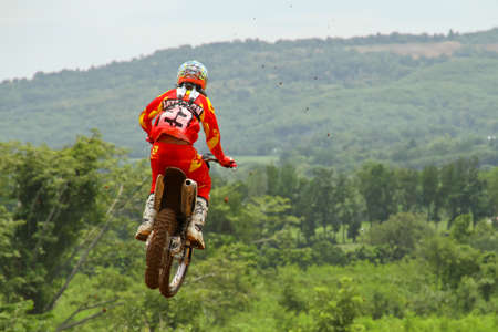Motocross bike in a race. 
FMSCT Thailand Supercross 2013, Round 7 - Saraburi Race 
Nawaphop MX Muaklek Saraburi Thailand on August 4, 2013.のeditorial素材