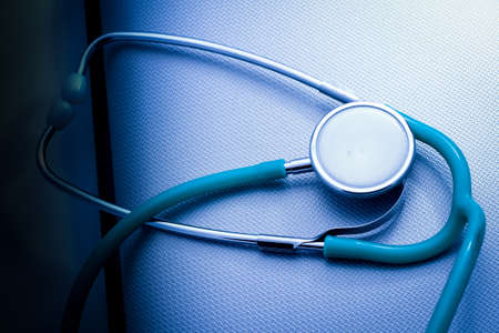 Stethoscope on the metal blue surface background.の写真素材