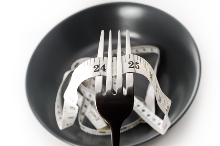 Diet concept  Plate fork and measure tape の写真素材