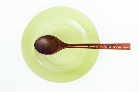 Empty green plate with wood spoon の写真素材