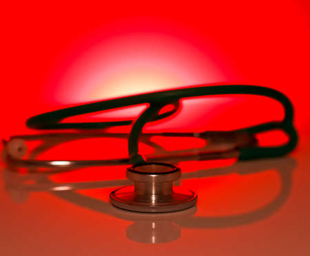 Red abstract background with stethoscope medical の写真素材