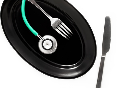 Serving the health  Plates fork and stethoscope の写真素材