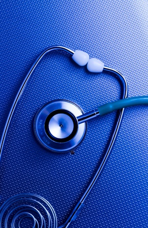 Stethoscope on the metal blue surface background の写真素材