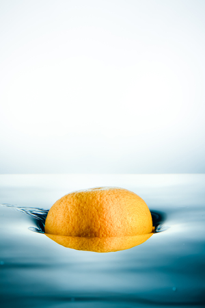 Fresh oranges dropped into water.の写真素材