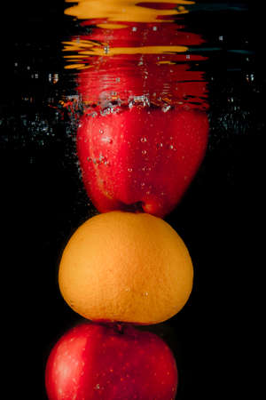 Fresh fruit submerged under water.の写真素材