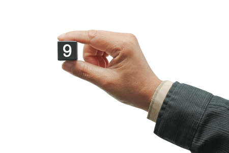 Hand with black number square dice, isolated on white.の写真素材