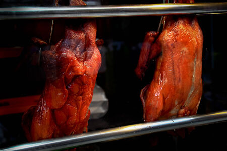 Peking Duck, China's food most famous. Duck roast hanging cupboard glass.の写真素材