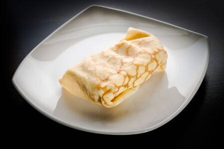 Dessert crepes on a white plate.の写真素材