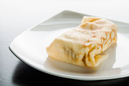Dessert crepes on a white plate.の写真素材