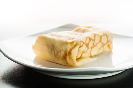Dessert crepes on a white plate.の写真素材