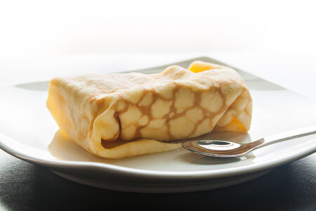 Dessert crepes on a white plate.の写真素材