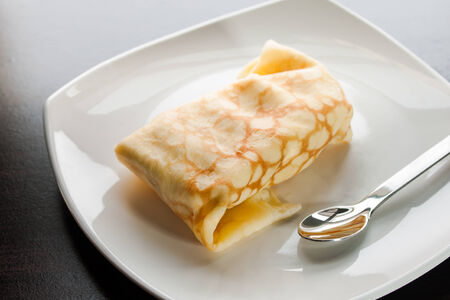 Dessert crepes on a white plate.の写真素材