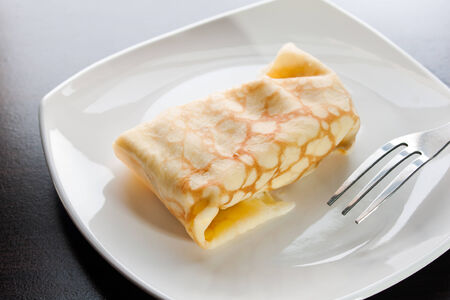 Dessert crepes on a white plate.の写真素材