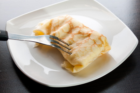 Dessert crepes on a white plate.の写真素材