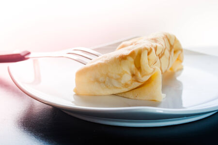 Dessert crepes on a white plate.の写真素材
