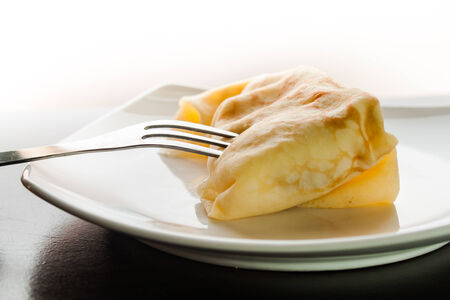 Dessert crepes on a white plate.の写真素材