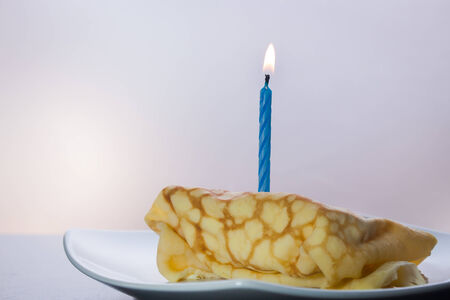 Dessert crepes on a white plate. Crepe Cake Candle.の写真素材