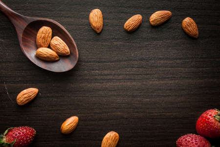 Almond and strawberries with space on wooden background. Vintage style.の写真素材