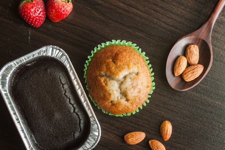 Banana cup cake and chocolate cake on wooden background.の写真素材