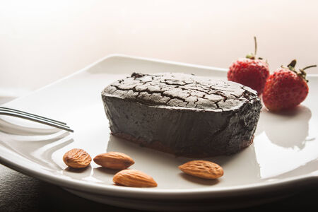 Chocolate cake with strawberries and almond.