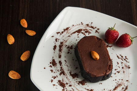 Chocolate cake with strawberries and almond.の写真素材