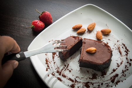 Chocolate cake with strawberries and almond.の写真素材