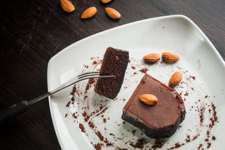 Dessert chocolate cake on a white plate. Eat dessert.の写真素材