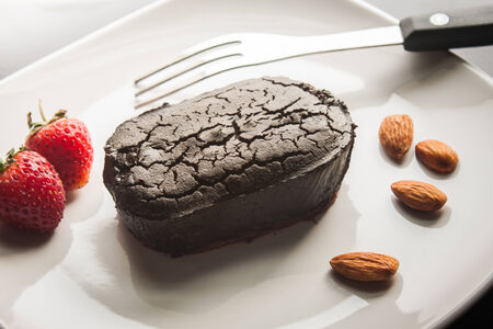 Chocolate cake with strawberries and almond.の写真素材