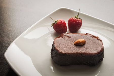 Chocolate cake with strawberries and almond.の写真素材