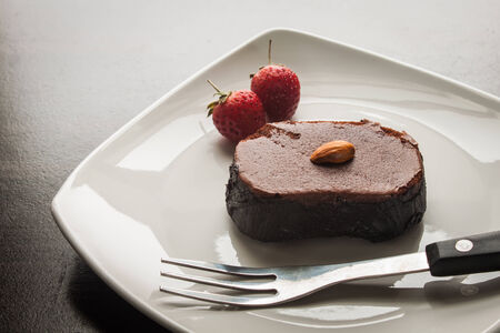 Chocolate cake with strawberries and almond.の写真素材