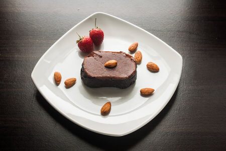Chocolate cake with strawberries and almond.の写真素材