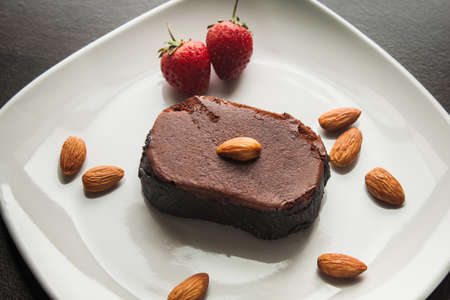 Chocolate cake with strawberries and almond.の写真素材