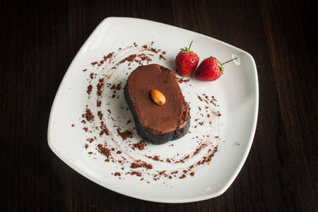 Chocolate cake with strawberries and almond.の写真素材