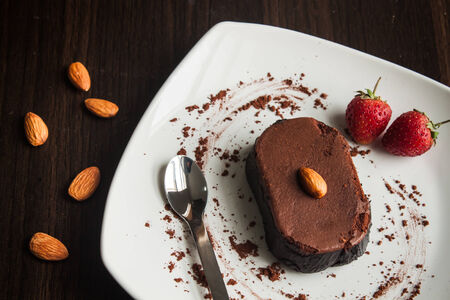 Chocolate cake with strawberries and almond.の写真素材