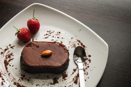 Chocolate cake with strawberries and almond.の写真素材