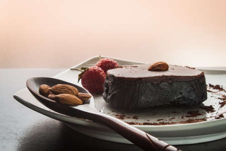 Chocolate cake with strawberries and almond.の写真素材