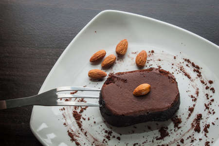 Dessert chocolate cake on a white plate. Eat dessert.の写真素材