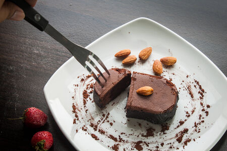 Chocolate cake with strawberries and almond.の写真素材