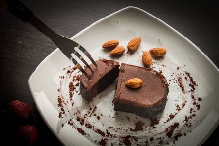 Chocolate cake with strawberries and almond.の写真素材