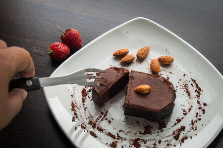 Chocolate cake with strawberries and almond.の写真素材