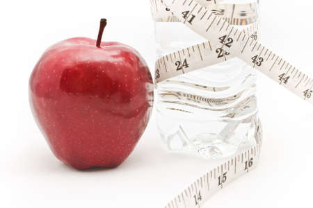 Apple and water. Tape measure waist as a symbol of diet.の写真素材
