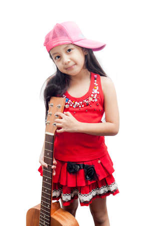 Confident little girl standing with her guitar.の写真素材