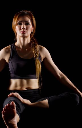 Portrait of pretty young woman doing yoga exercise.の写真素材